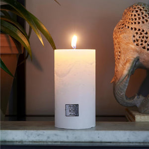 Riviera Maison Rustic Candle Frosted White 7X13 lit up on worktop
